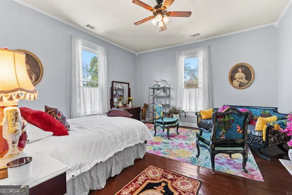 a bedroom with bed and a chandelier