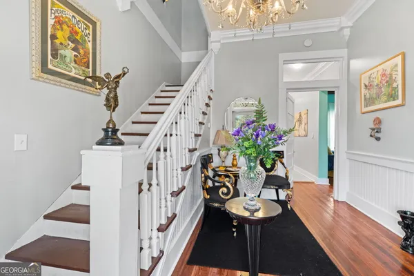 a dining room with furniture and wooden floor