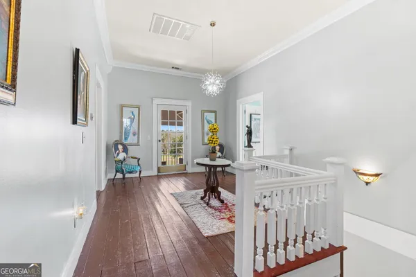 a view of a livingroom with furniture and hardwood floor