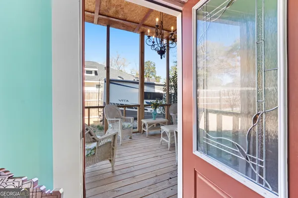 a view of a living room and a balcony