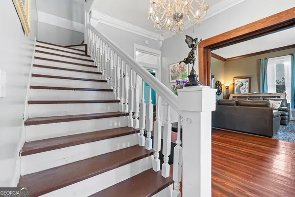 a view of entryway and hall with wooden floor