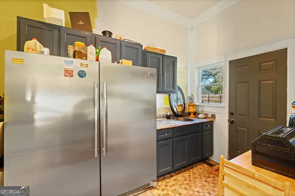 a kitchen with stainless steel appliances granite countertop a refrigerator and a stove