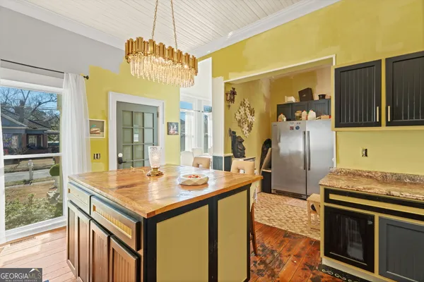 a kitchen with stainless steel appliances granite countertop a sink and a refrigerator