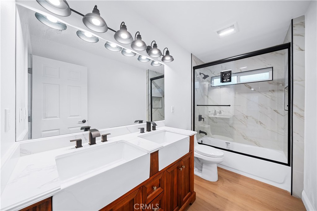 10877 Cameron Court Corona, CA 92883 - Photo 14 of 31 a bathroom with a double vanity sink mirror and toilet
