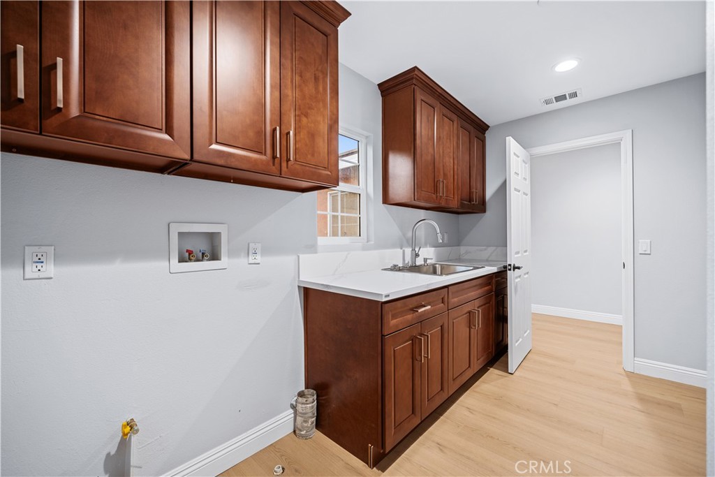 10877 Cameron Court Corona, CA 92883 - Photo 18 of 31 a kitchen with stainless steel appliances granite countertop a sink stove and cabinets