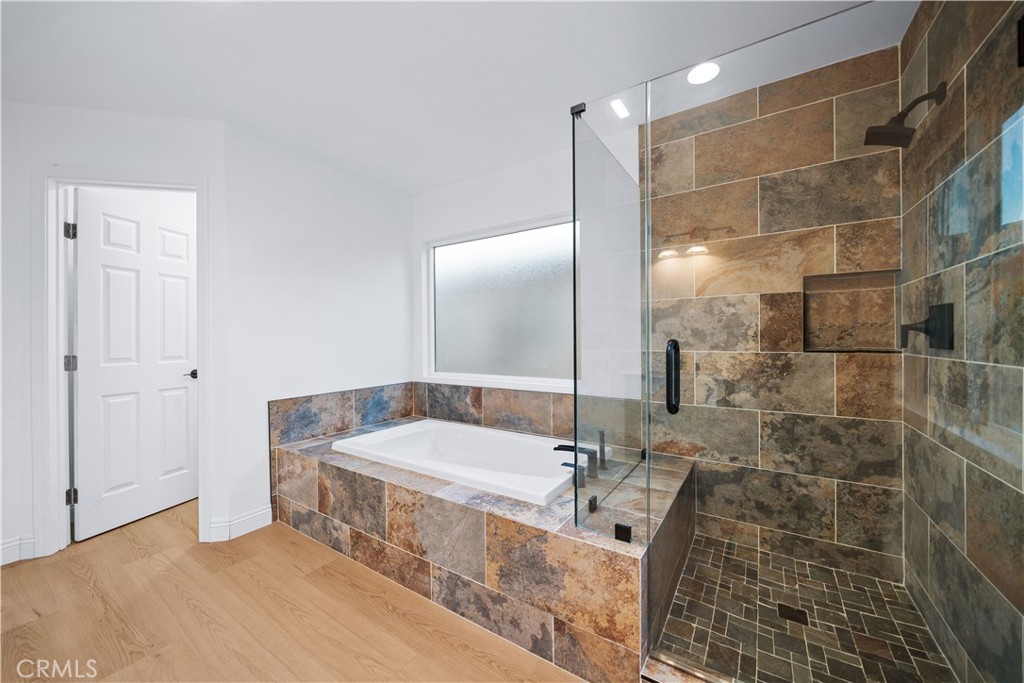 10877 Cameron Court Corona, CA 92883 - Photo 23 of 31 a bathroom with a tub and shower