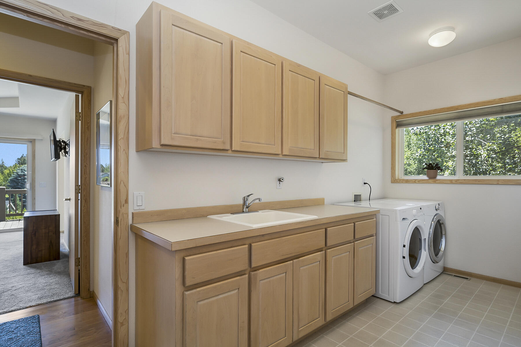 61524 Southeast Hill Ridge Road Bend, OR 97702 - Photo 20 of 49 Utility room with custom built counters, sink. Washer & Dryer stay.