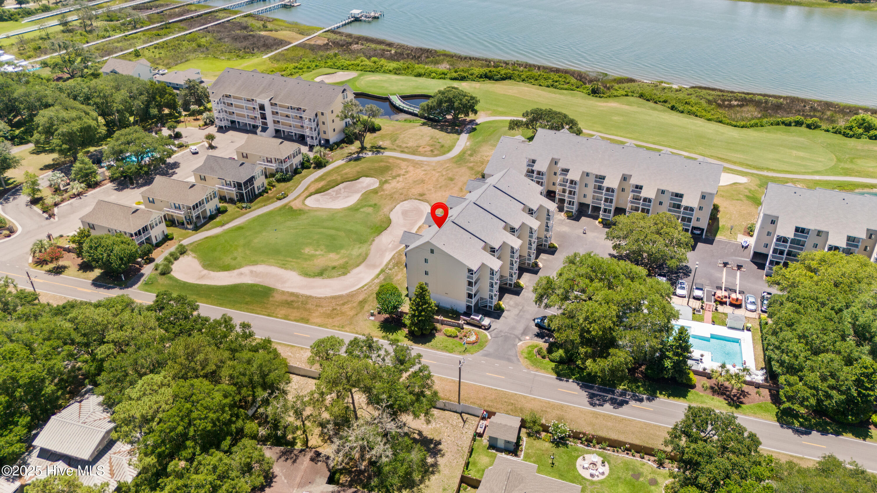 This is Mariner's Wacche condo location with views of golf course fairway # 2. and the ICW and pool in front of unit, but red arrow is pointing to the building this condo located in. Unit 2104 is a first floor unit, first staircase. Wonderful views, wonderful location, wonderful new price just reduced 20,000.