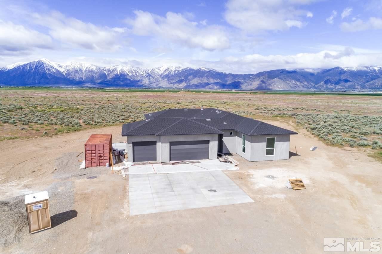 2006 East Valley Road Minden, NV 89423 - Photo 2 of 25 a front view of a house with a yard and mountain view in back