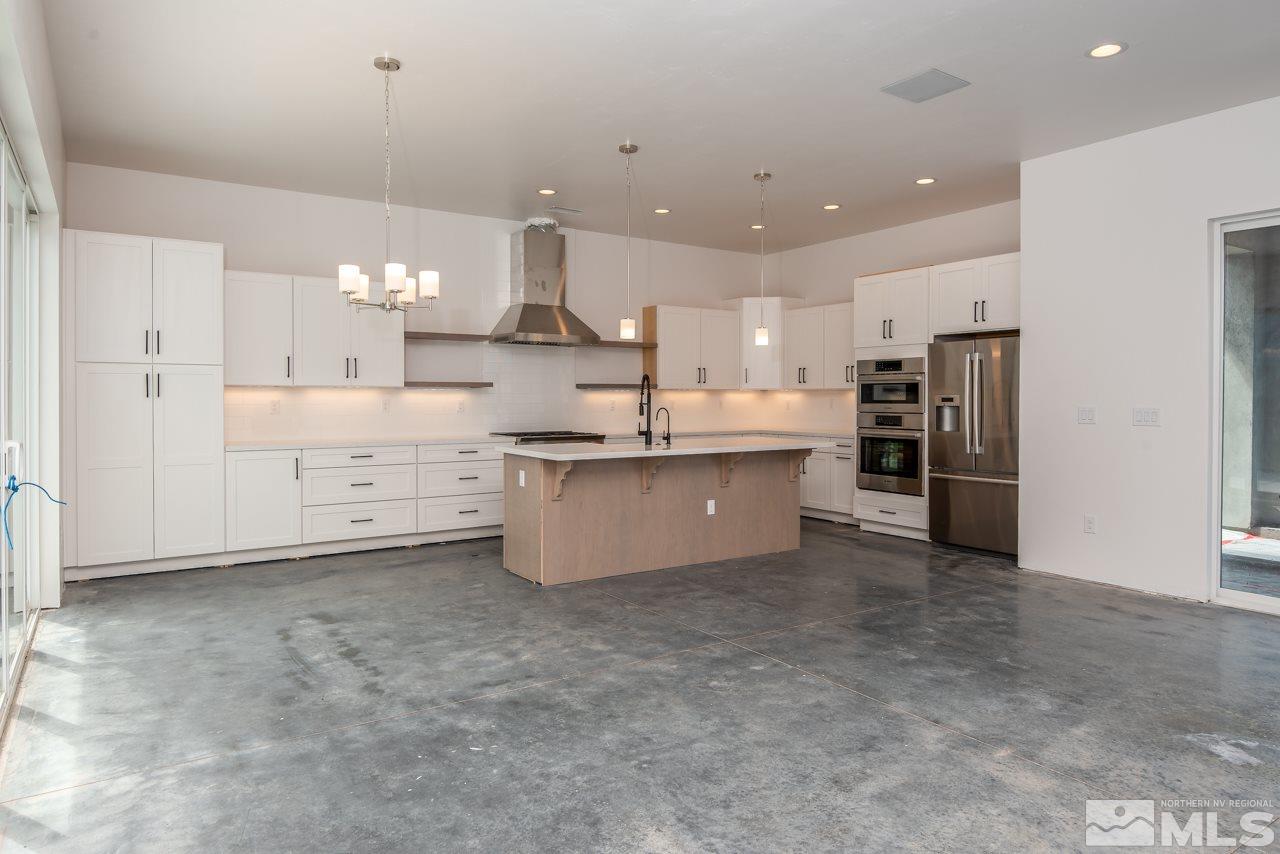 2006 East Valley Road Minden, NV 89423 - Photo 5 of 25 a large kitchen with stainless steel appliances lots of counter space and a sink