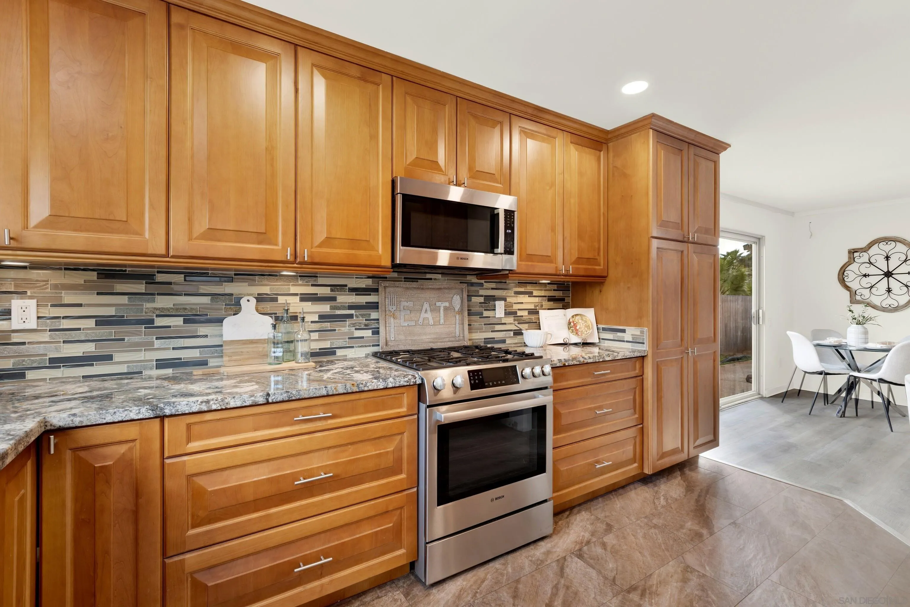 14545 Hillndale Way Poway, CA 92064 - Photo 18 of 52 a kitchen with granite countertop wooden cabinets and stainless steel appliances