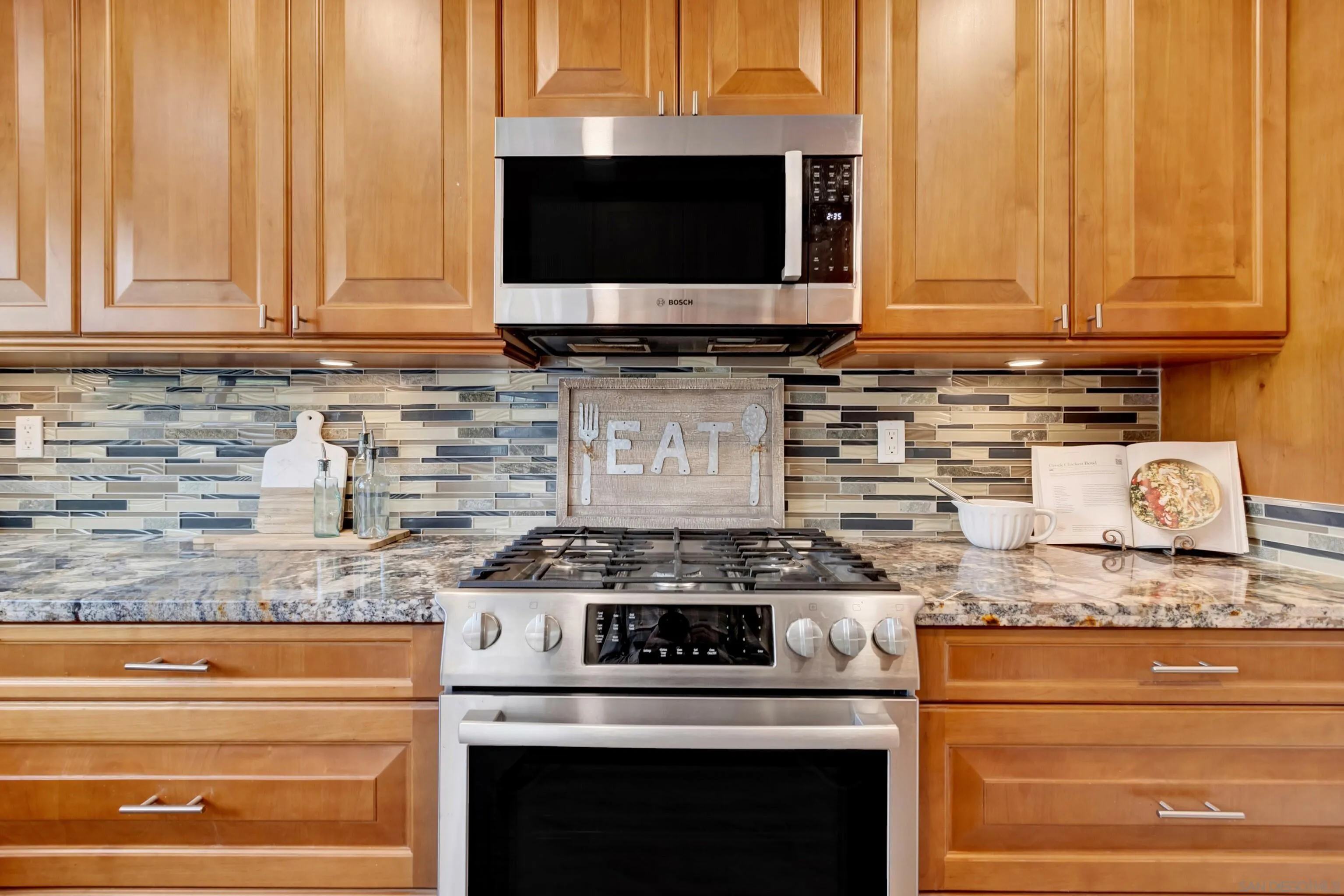 14545 Hillndale Way Poway, CA 92064 - Photo 19 of 52 a kitchen with granite countertop white cabinets and stainless steel appliances