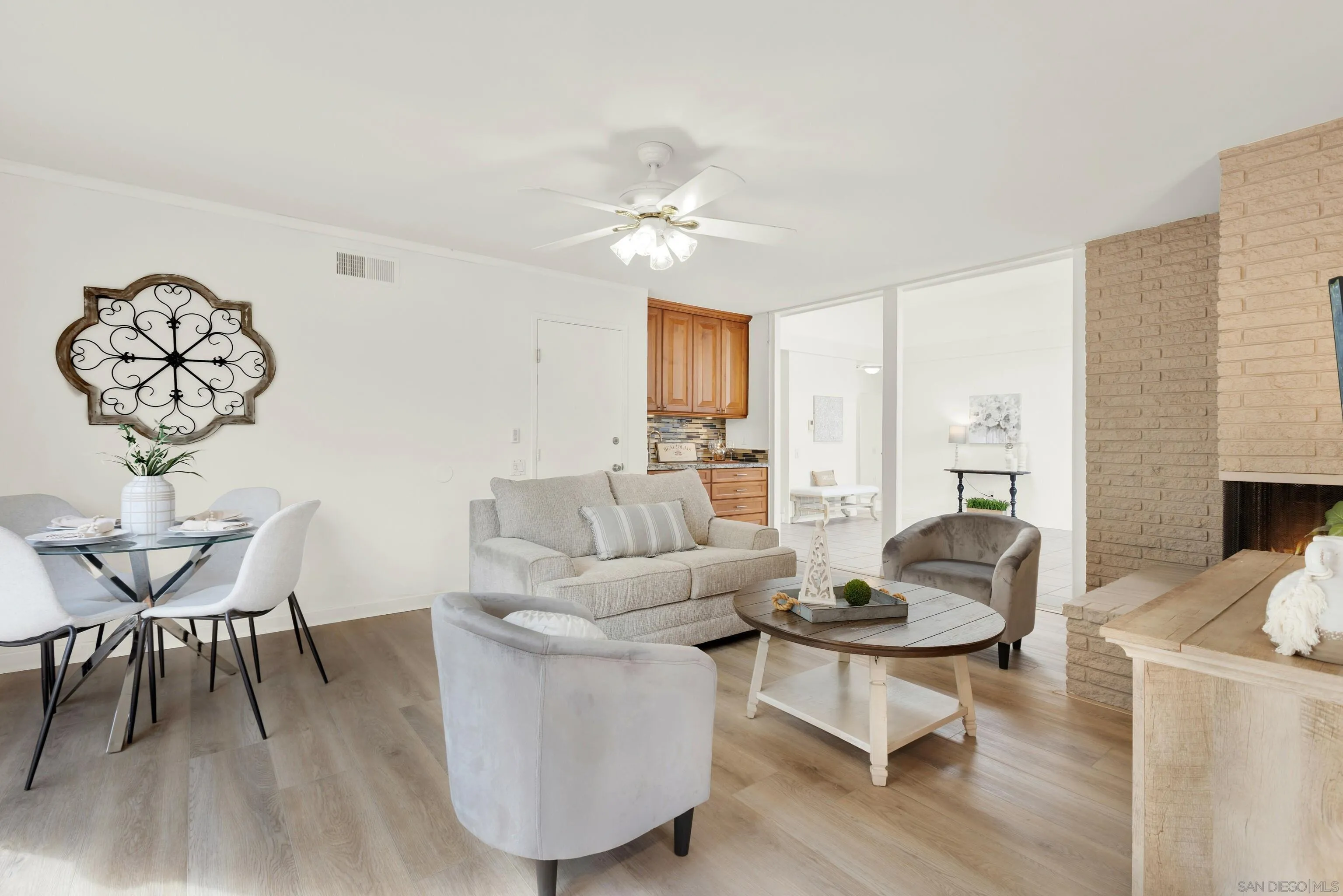 14545 Hillndale Way Poway, CA 92064 - Photo 22 of 52 a living room with furniture a dining table and a fireplace