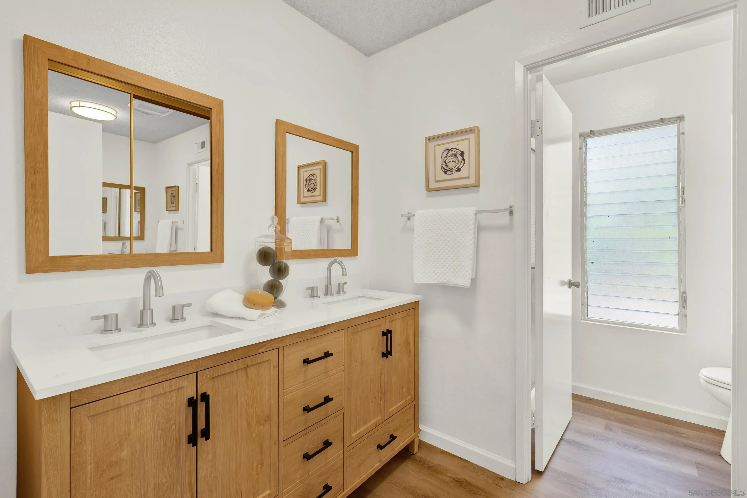 14545 Hillndale Way Poway, CA 92064 - Photo 29 of 52 a bathroom with a double vanity sink mirror and