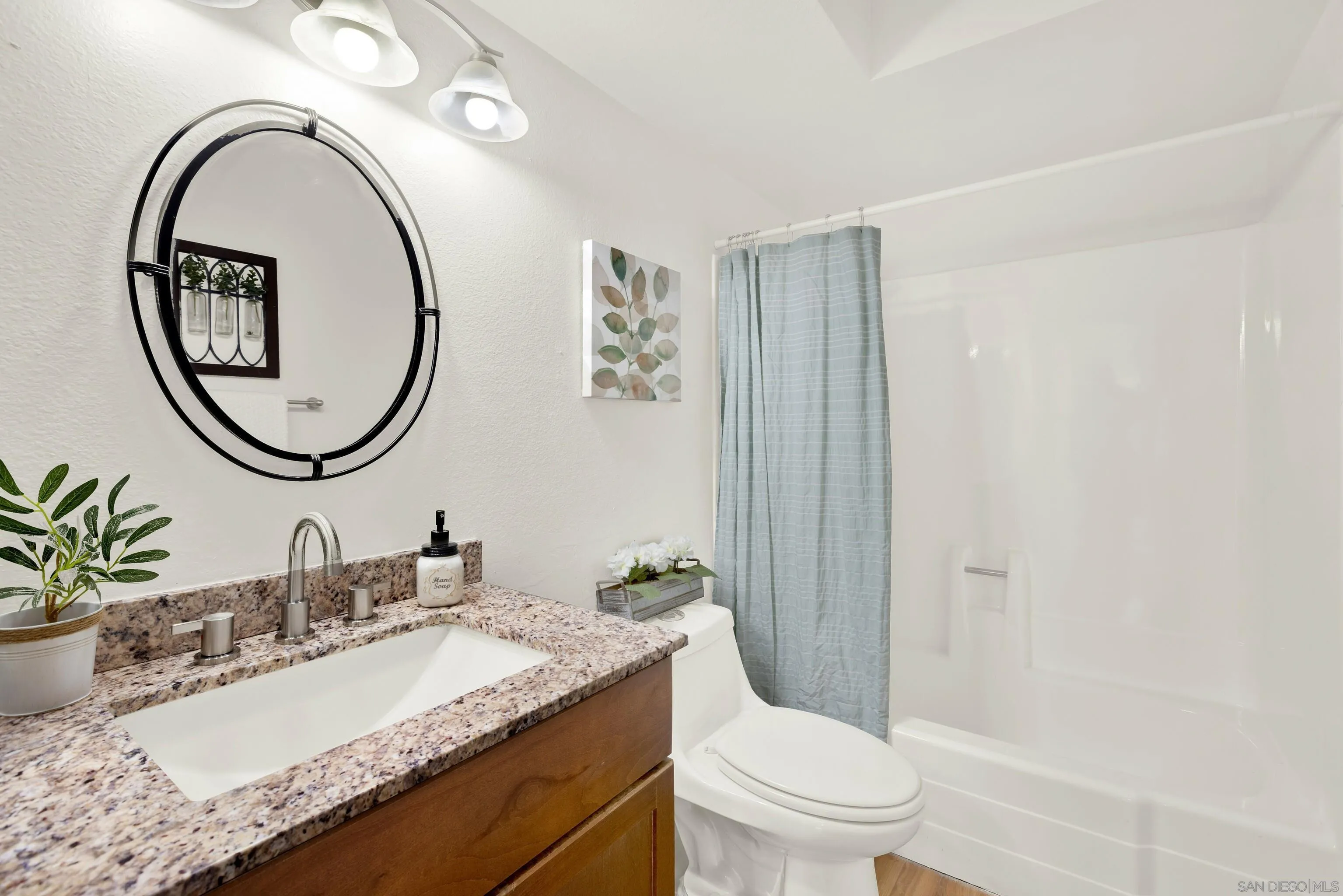 14545 Hillndale Way Poway, CA 92064 - Photo 43 of 52 a bathroom with a granite countertop toilet a sink and a mirror