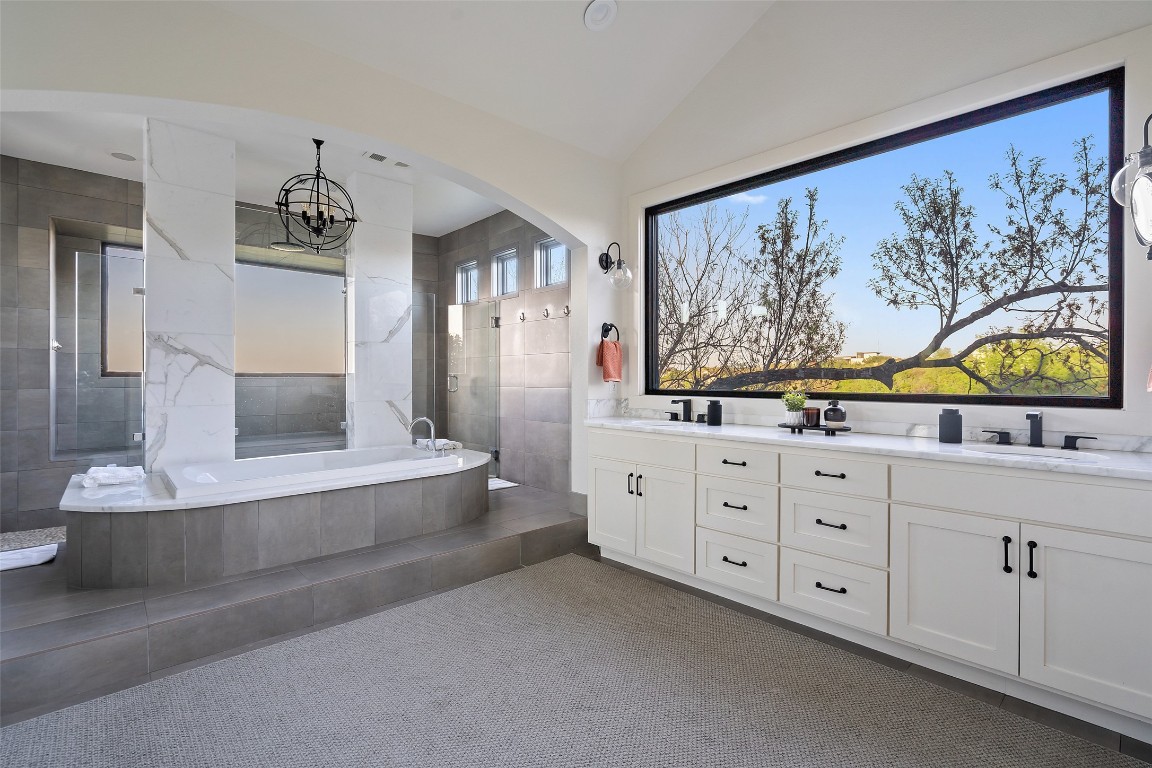 29 Pascal Lane Austin, TX 78746 - Photo 14 of 38 a spacious en suite bathroom with a double vanity sink and a bathtub