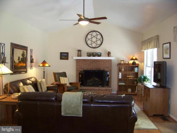 24 Farm Ridge Court Baldwin, MD 21013 - Photo 11 of 30 a living room with furniture a clock and a flat screen tv