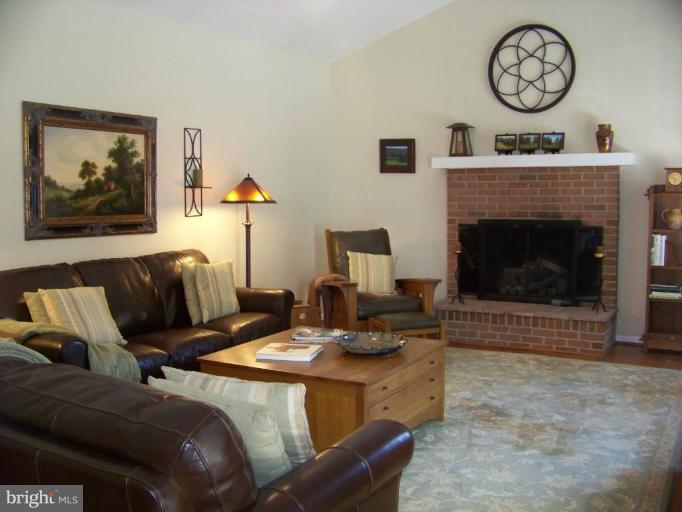 24 Farm Ridge Court Baldwin, MD 21013 - Photo 10 of 30 a living room with furniture a clock and a fireplace