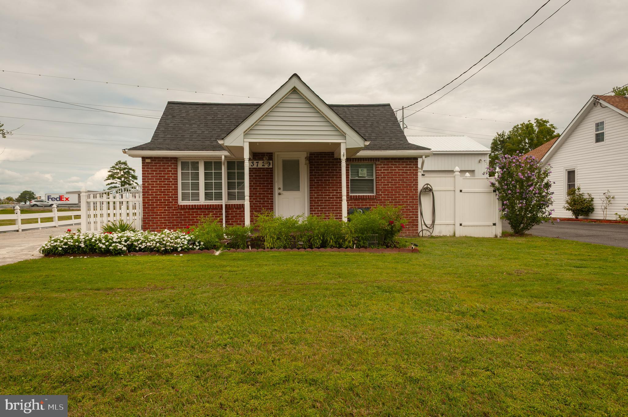 3729 Main Street Grasonville, MD 21638 - Photo 1 of 30 a front view of a house with a garden