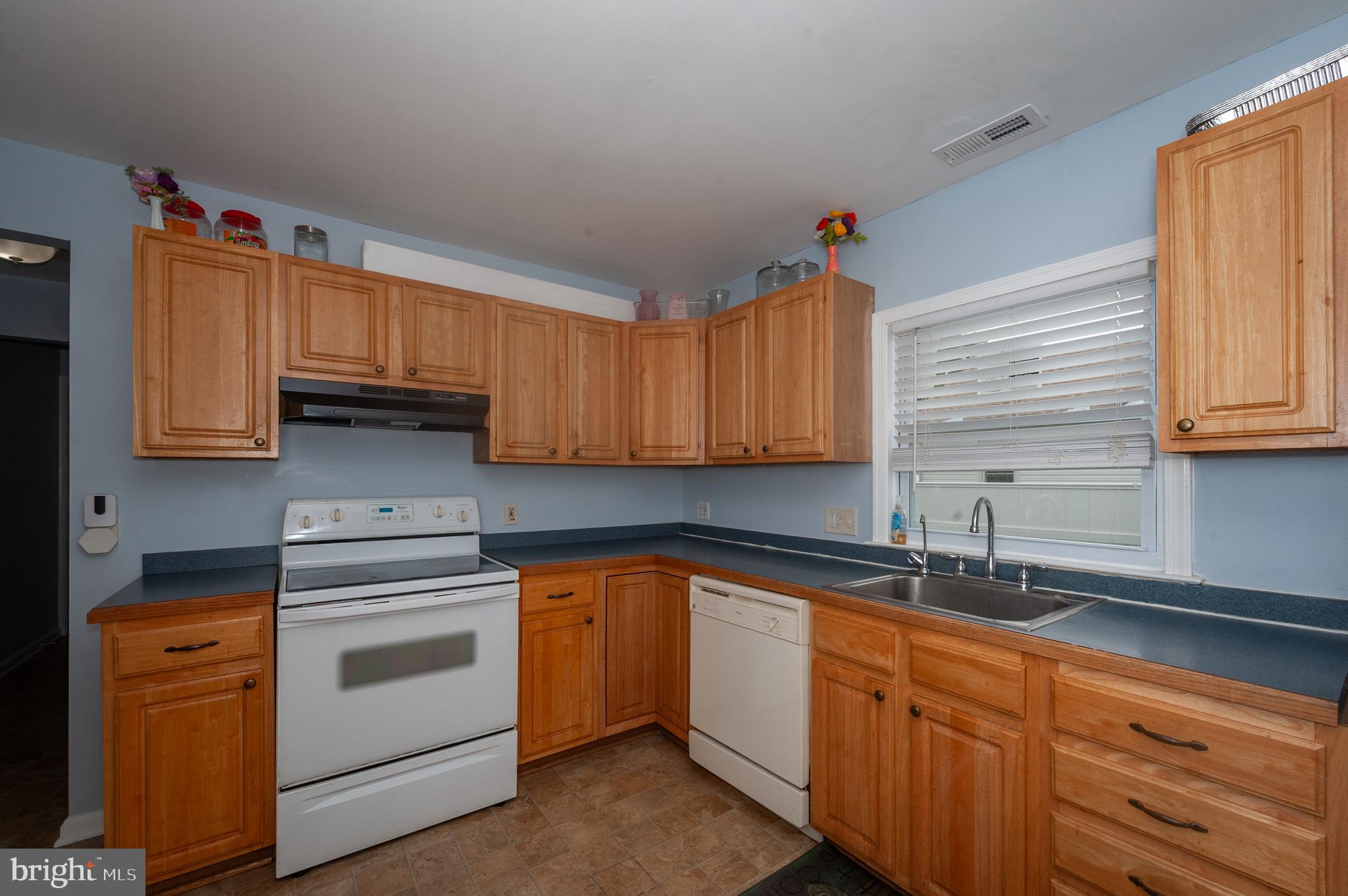3729 Main Street Grasonville, MD 21638 - Photo 11 of 30 a kitchen with cabinets appliances a sink and a window