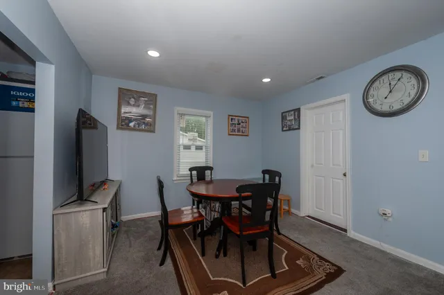 a view of a dining room with furniture and a clock