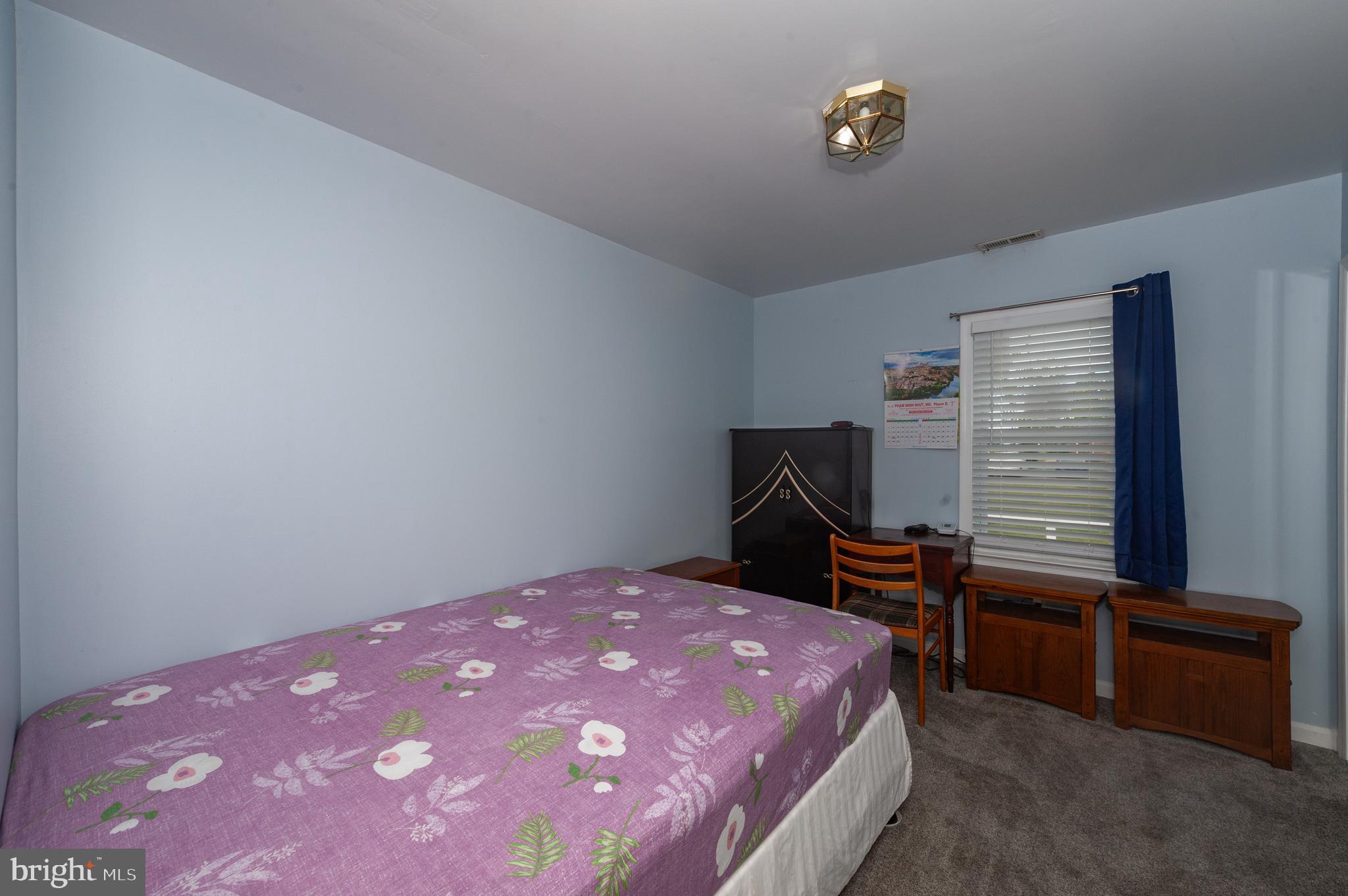 3729 Main Street Grasonville, MD 21638 - Photo 18 of 30 a bedroom with a bed and a window