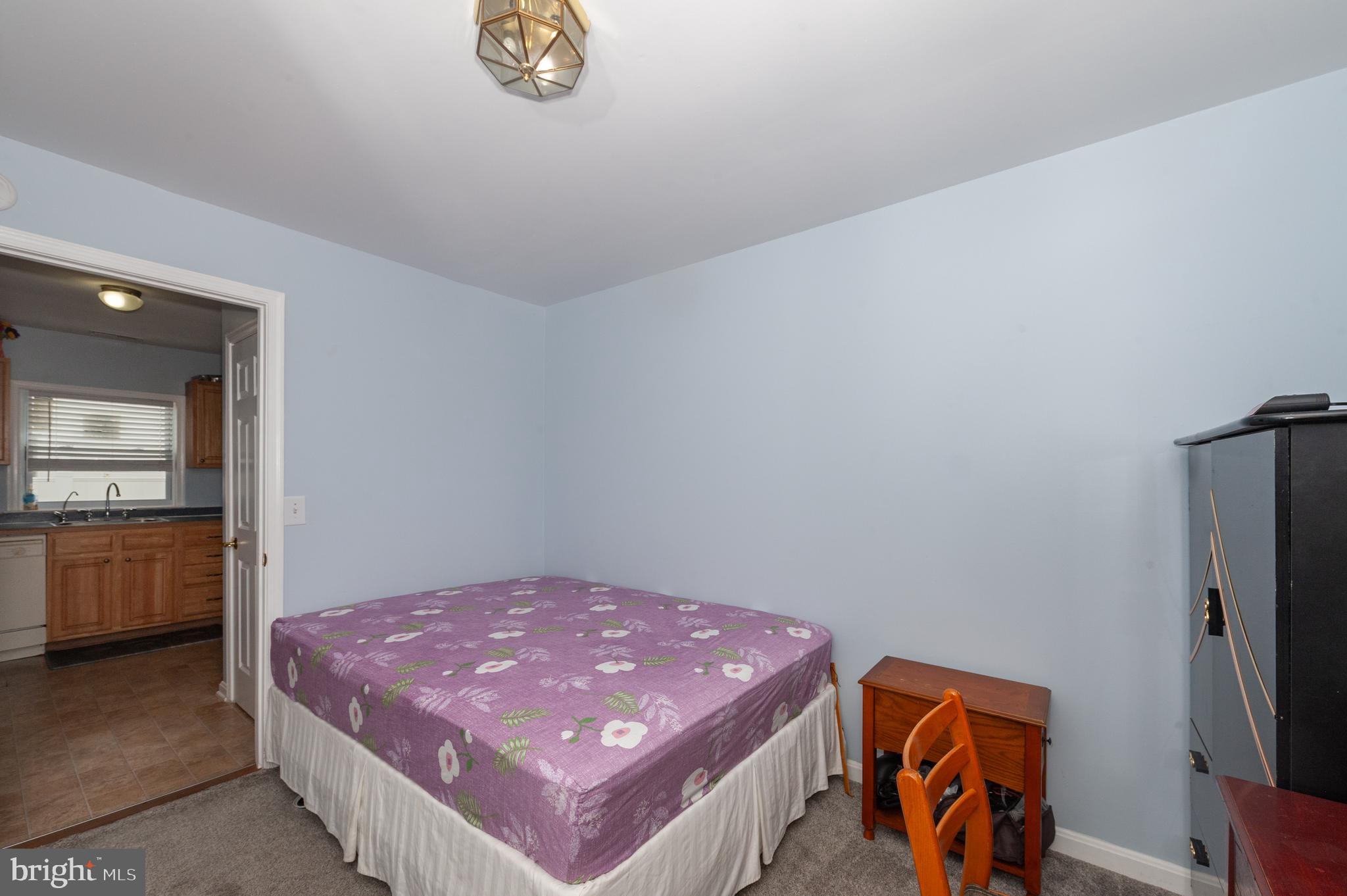 3729 Main Street Grasonville, MD 21638 - Photo 19 of 30 a spacious bedroom with a bed and a flat screen tv