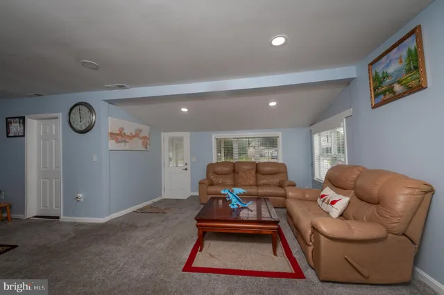 a living room with furniture a rug and a large window