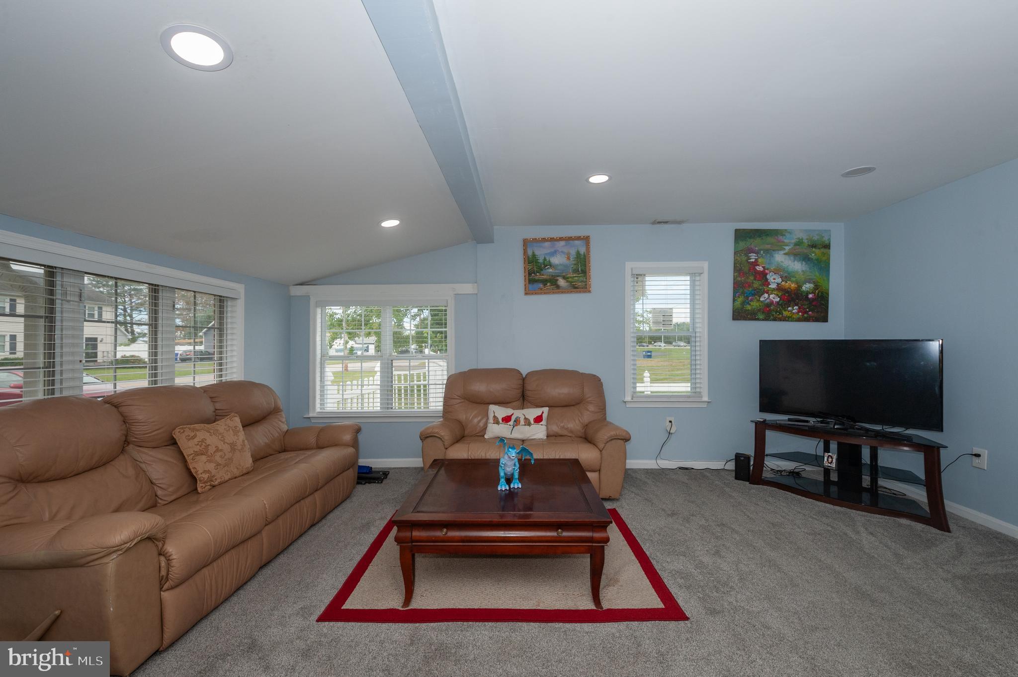 3729 Main Street Grasonville, MD 21638 - Photo 8 of 30 a living room with furniture a flat screen tv and a large window