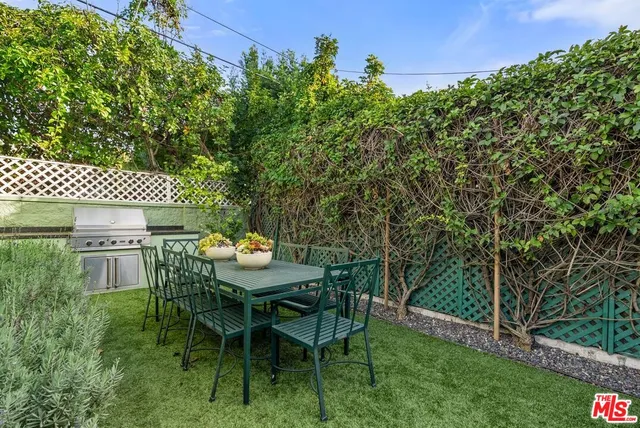 a backyard of a house with table and chairs