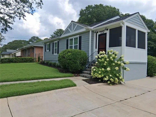 a front view of a house with a garden