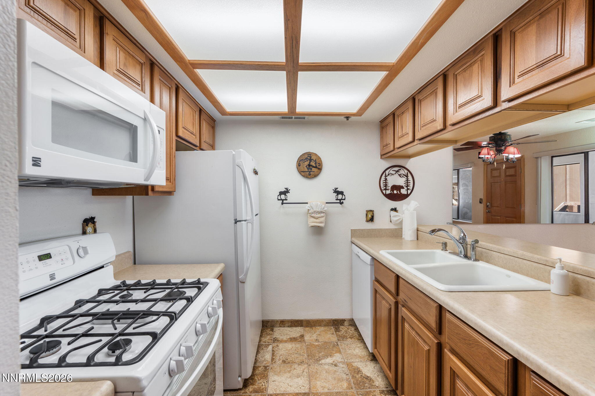 759 Boulder Court, Unit F Stateline, NV 89449 - Photo 12 of 36 a kitchen with stainless steel appliances granite countertop a stove and a sink