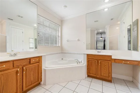 a bathroom with a tub sink shower and mirror