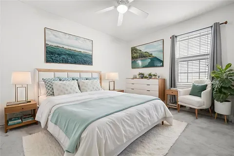 a bedroom with a bed and a painting on the wall