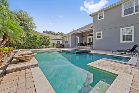 a view of a house with a backyard porch and sitting area