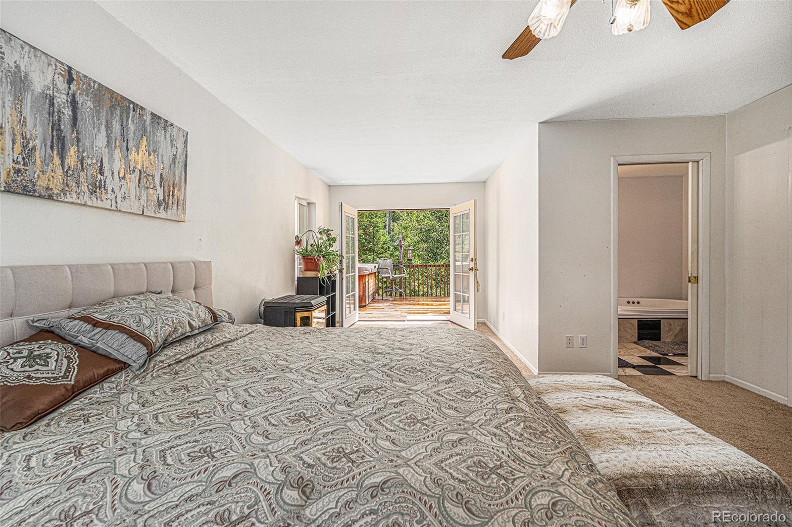 10142 South Turkey Creek Road Conifer, CO 80433 - Photo 19 of 48 a bedroom with a large bed and a window