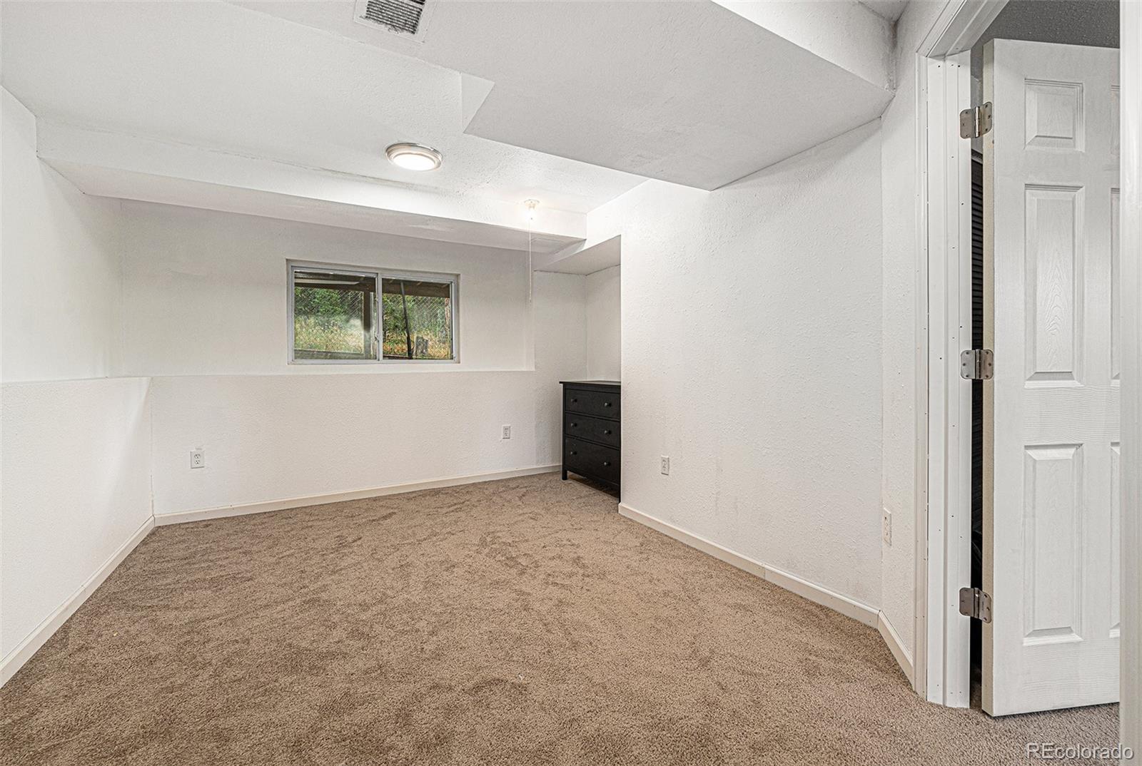 10142 South Turkey Creek Road Conifer, CO 80433 - Photo 24 of 48 a view of an empty room with a window