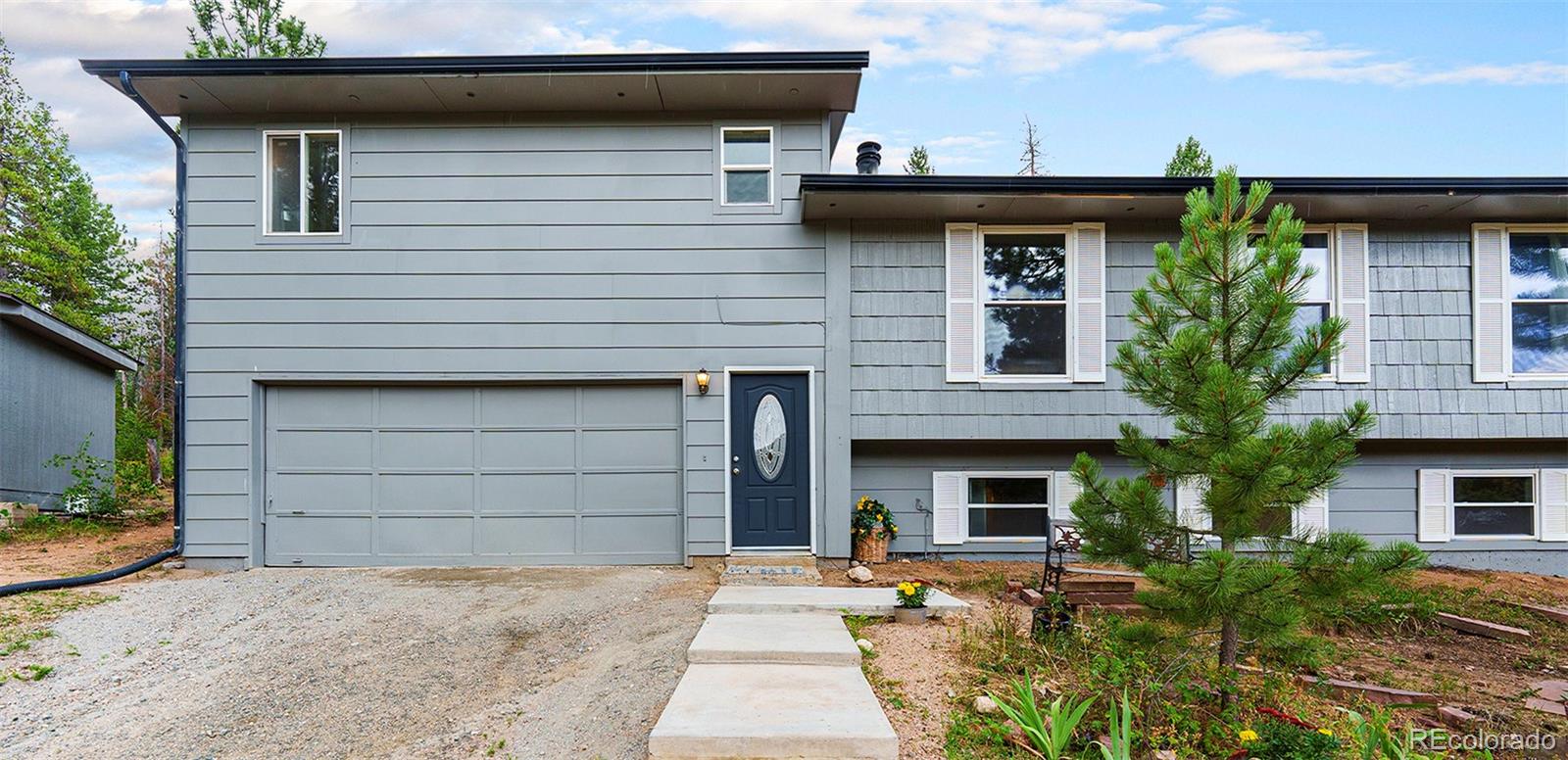 10142 South Turkey Creek Road Conifer, CO 80433 - Photo 5 of 48 a front view of a house with garage