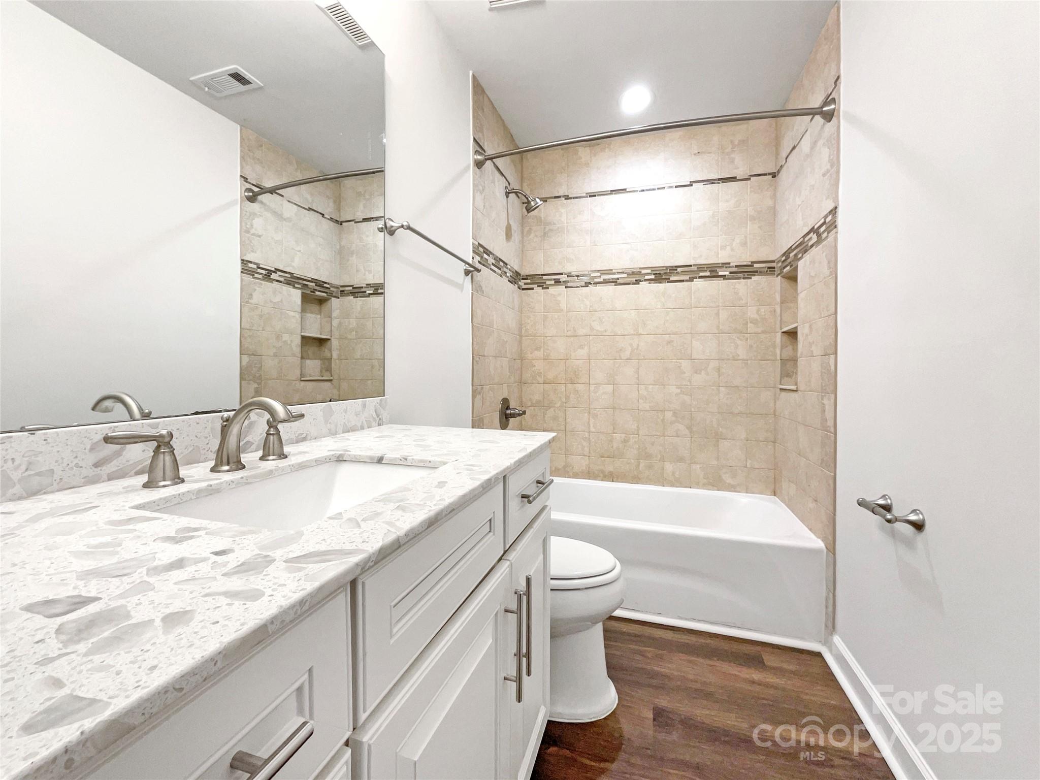 163 Scanlon Road Mooresville, NC 28115 - Photo 17 of 18 a bathroom with a granite countertop sink a toilet and shower