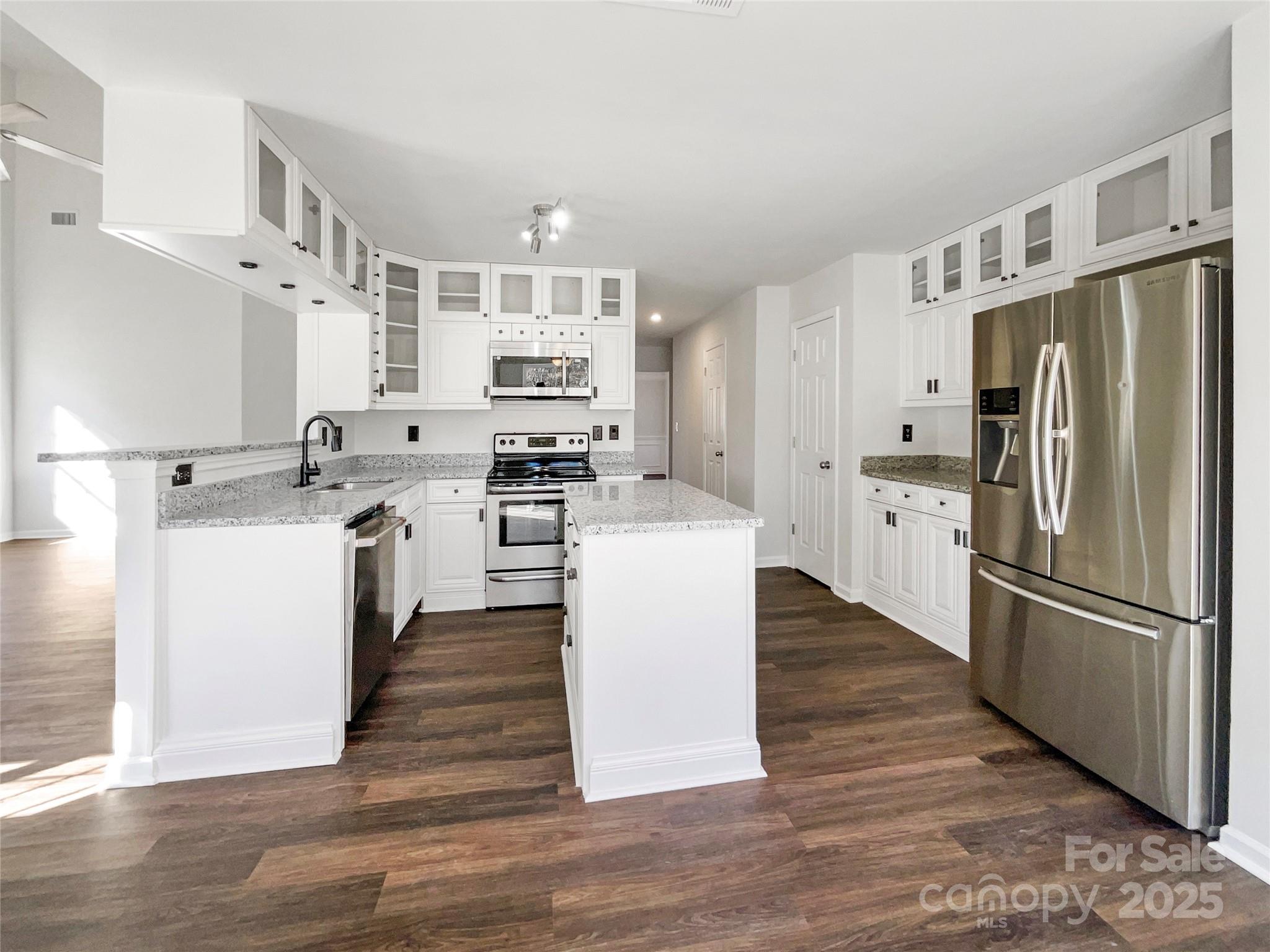 163 Scanlon Road Mooresville, NC 28115 - Photo 2 of 18 a kitchen with stainless steel appliances a refrigerator sink and cabinets