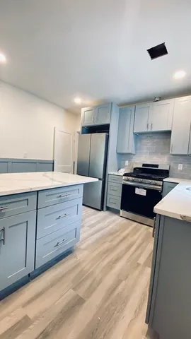 a kitchen with granite countertop a stove and a sink