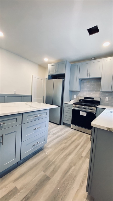 96 Brayton Road, Unit 1 Boston, MA 02135 - Photo 1 of 10 a kitchen with granite countertop a stove and a sink