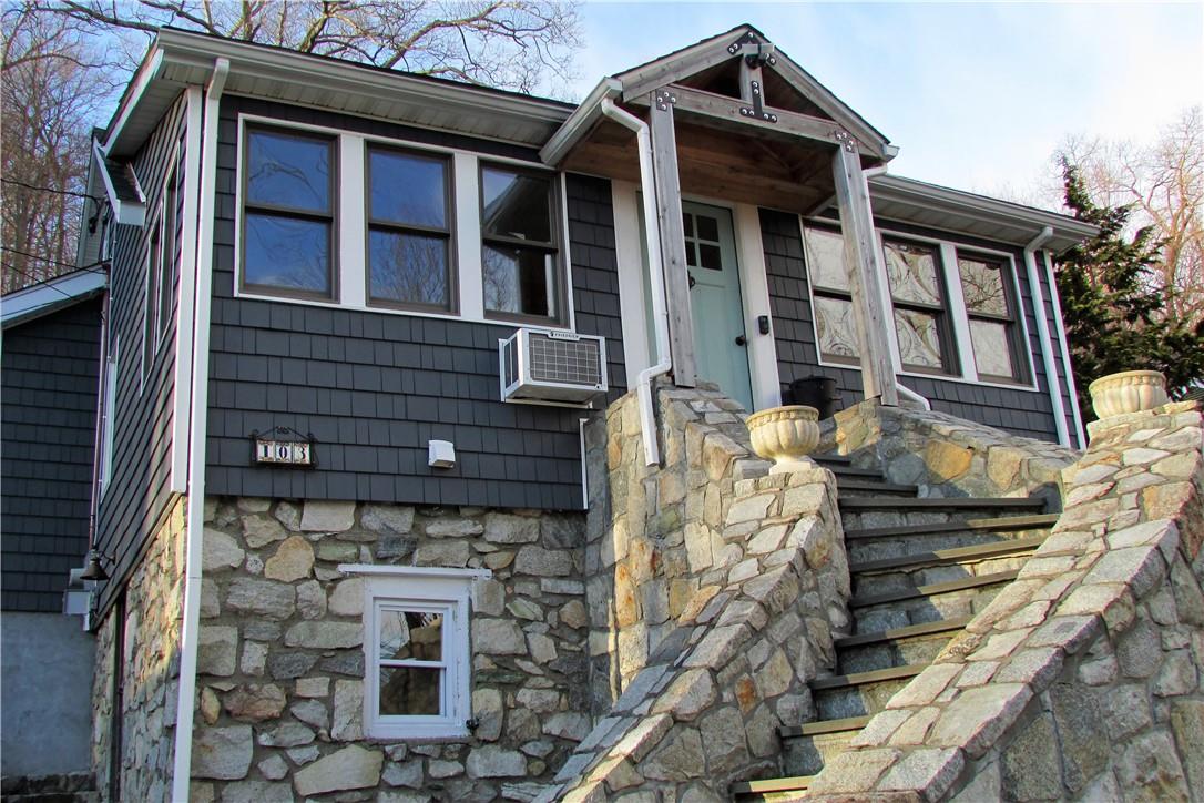 103 Tanglewylde Road Lake Peekskill, NY 10537 - Photo 1 of 1 a front view of a house with large windows