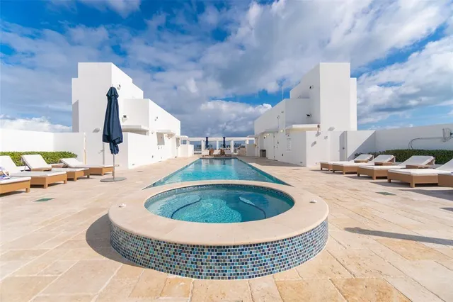 a view of swimming pool with outdoor seating