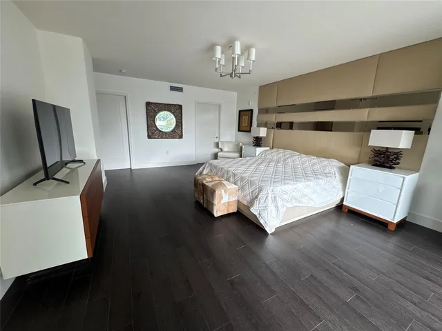 a bedroom with a bed and a television