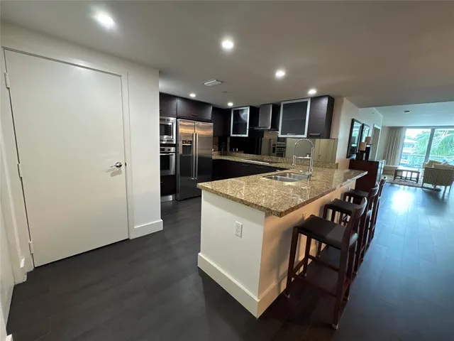 an open kitchen with a table and chairs in it