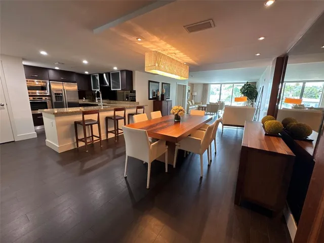 a dining room with furniture a rug and wooden floor