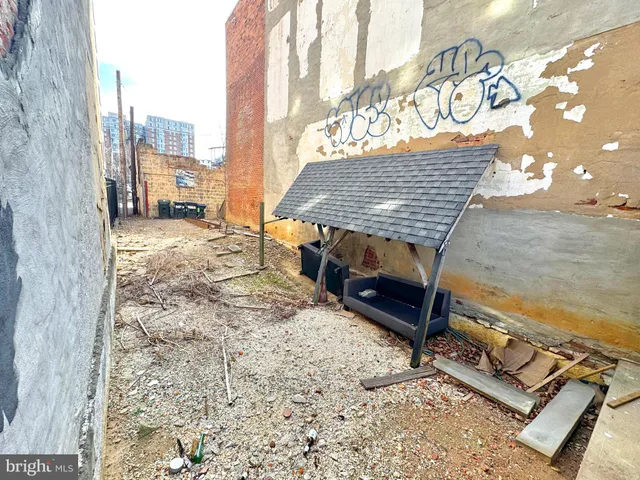 a view of a backyard with sitting area