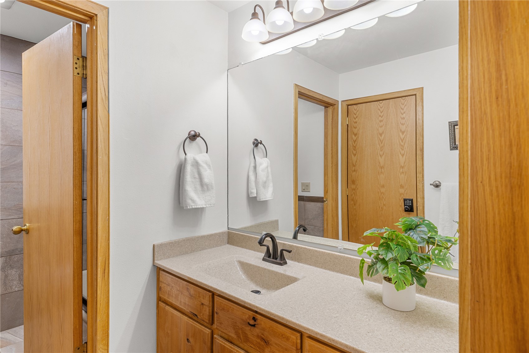 22804 Highway 6, Unit 102 Keystone, CO 80435 - Photo 15 of 34 a bathroom with a granite countertop sink a mirror and a shower