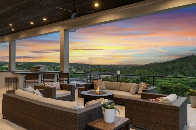 a view of a roof deck with couches and potted plants